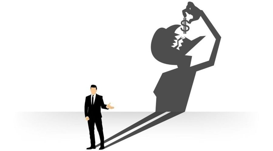 conceptual of businessman casting a shadow eating dollar_shutterstock_369006632 900x500