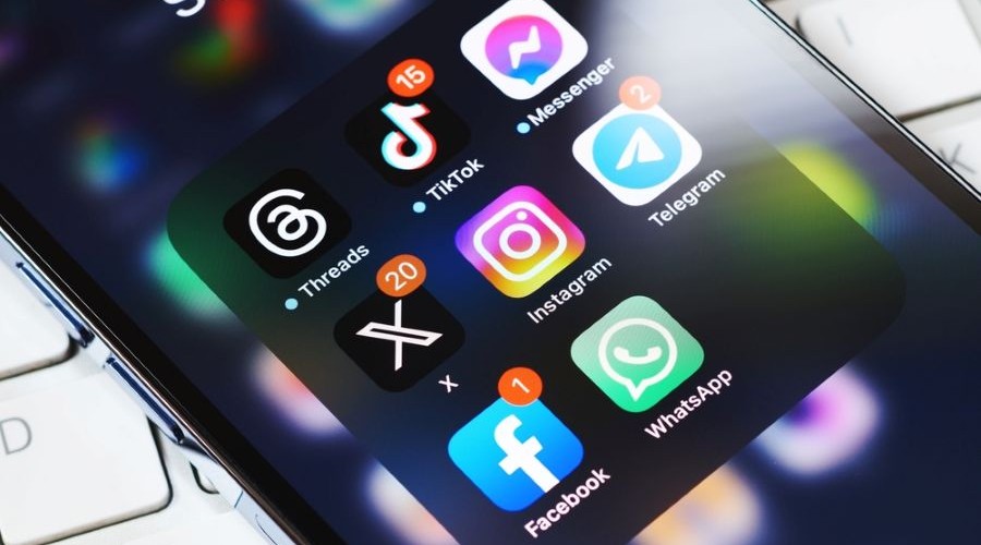 social media icons on iphone_shutterstock_2339442245 900x500