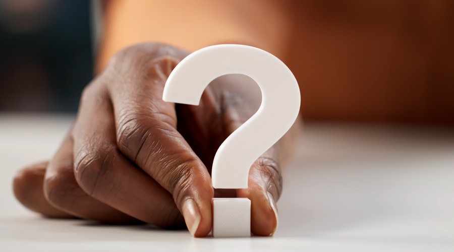 hand holding white question mark_shutterstock_2736049601 900x500